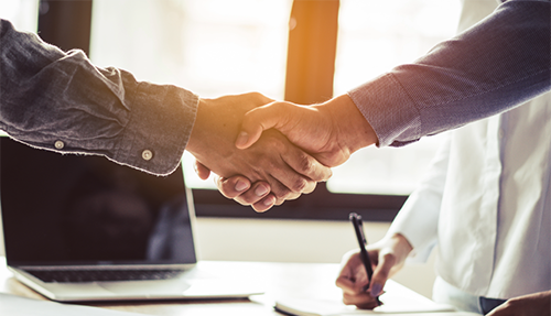 A closeup of two people shaking hands